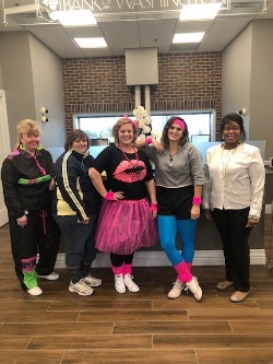 Bank employees dressed up as ladies from the 80's